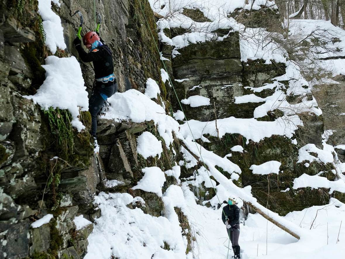 Students rock climbing in the snow