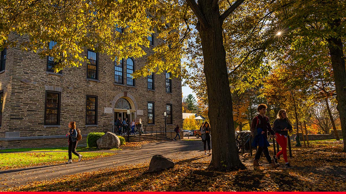 Scenic autumn view of students walking near Alumni Hall