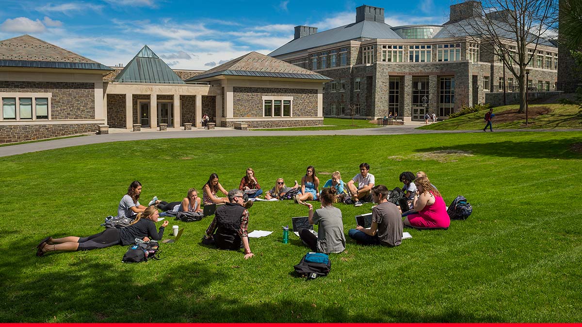 A class meets on the Quad on a sunny day in front of Olin Hall