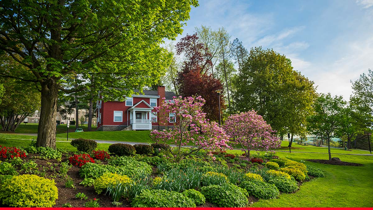 Scenic spring view of the Merrill House gardens in bloom in front of the former La Casa house